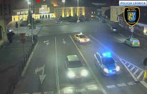Zdjęcie z kamer monitoringu obrazujące skrzyżowanie ulic Dworcowa a Kolejowa na którym widać radiowóz jadący na synale a z nim  taksówka.