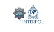 Policyjna odznaka z napisem KMP Siedlce i obok logo Interpolu, a pod nim napis Interpol