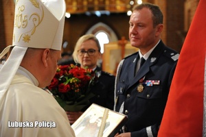 Biskup otrzymuje obraz od Komendanta Wojewódzkiego Policji.
