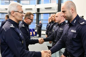 zastępcy komendanta wojewódzkiego gratulują stojącym w szeregu policjantom