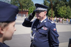 Komendant Wojewódzki Policji we Wrocławiu nadinspektor Dariusz Wesołowski oddaje honory, poprzez dotknięcie palcami wskazującym i środkowym prawej ręki rantu własnej czapki.