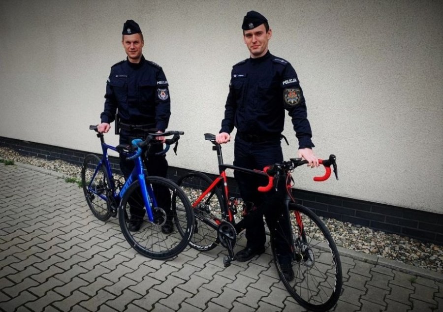Dwaj umundurowani policjanci stoją przy rowerach