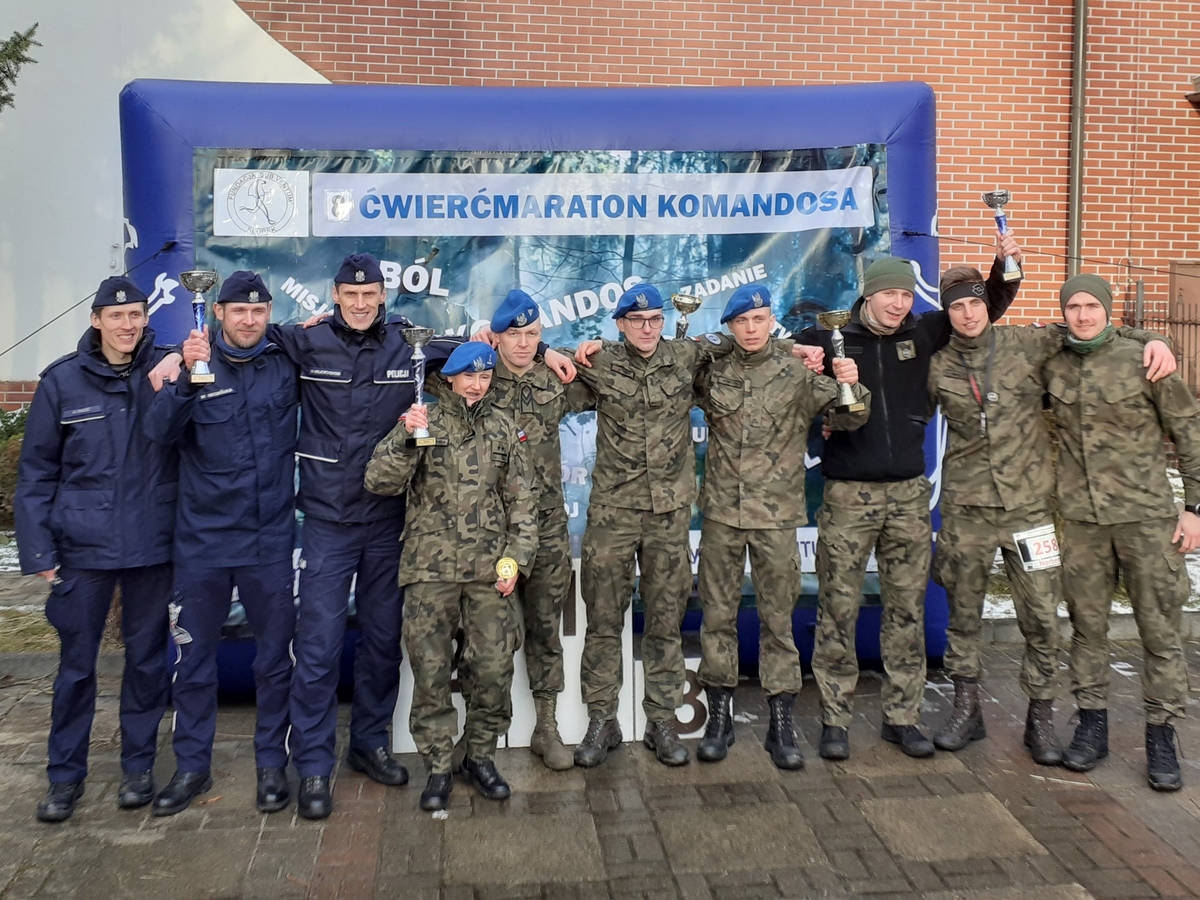zdjęcie grupowe, policjanci i żołnierze, kilku z nich trzyma puchary