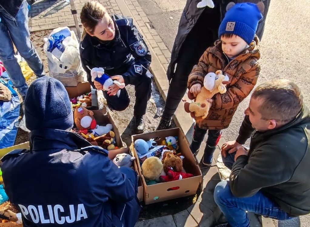 policjantka rozdaje dzieciom maskotki 