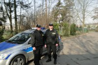 policjanci na tle radiowozu