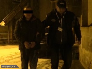 policjant prowadzi podejrzanego