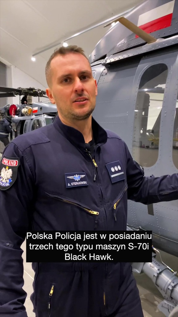 Policyjny pilot obok śmigłowca.