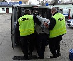 Policjanci prowadzą zatrzymanego