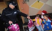 policjant wręcza dzieciom prezenty