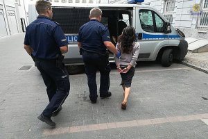 policjant prowadzi zatrzymaną