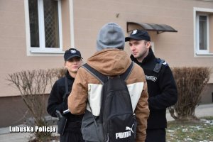 policjant i policjantka rozmawiają z przechodniem