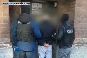 policjanci prowadzą zatrzymanego