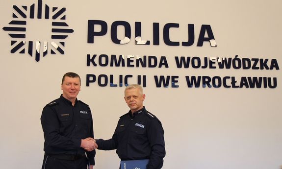 Asp. szt. Paweł Petrykowski i nadkom. Krzysztof Zaporowski. W tle napis: Komenda Wojewódzka Policji we Wrocławiu