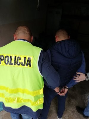 policjant z zatrzymanym mężczyzną