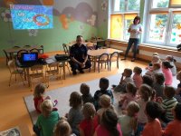 policjant rozmawia z dziećmi w przedszkolu o bezpieczeństwie