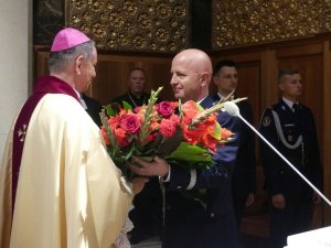 Komendant Główny Policji gen. insp. Jarosław Szymczyk wręcza kwiaty bp gen. bryg. Józefowi Guzdkowi