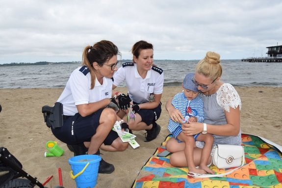 policjantki rozmawiają na plaży o bezpieczeństwie