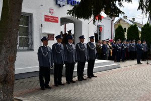 Uroczystość otwarcia Posterunku Policji w Tykocinie. Na zdjęciu widoczni są policjanci w rzędzie. W tle budynek.