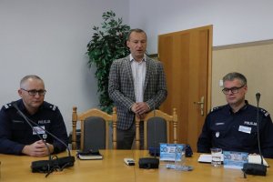 jeden z uczestników narady stoi i przemawia do innych uczestników narady