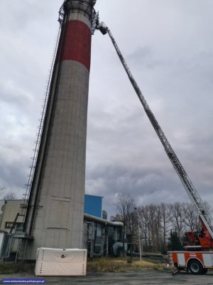 Komin na którym stoi mężczyzna chcący skoczyć w dół