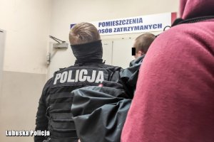 zatrzymani mężczyźni prowadzeni przez policjantów do izby zatrzymań