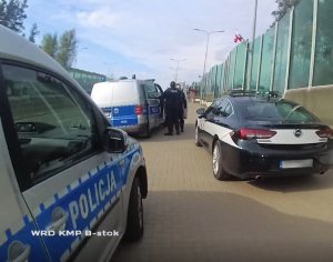 policyjne radiowozy i auto żandarmerii wojskowej - zrzut ekranu zrobiony z filmu z kamery nasobnej umieszczonej na mundurach