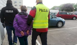 policjanci prowadzą zatrzymaną