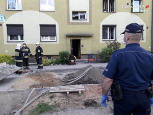 Służby zabezpieczają miejsce pożaru w bloku mieszkalnych przy ulicy Patriotów w Rybniku-Boguszowicach