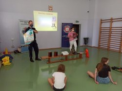 policjant rozmawia z dziećmi o bezpieczeństwie