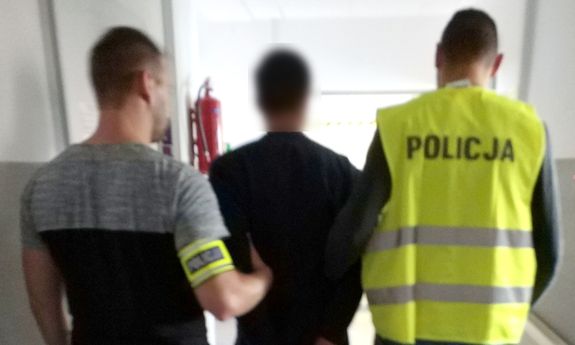 policjanci prowadzą zatrzymanego