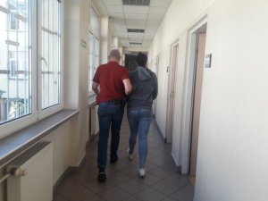 Policjant prowadzi zatrzymanego