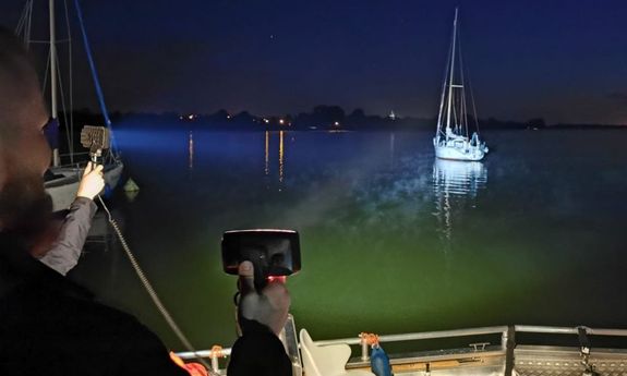 Częściowo widoczna łódź na zbiorniku wodnym w porze nocnej