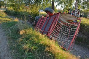 przewrócony traktor rolniczy z maszyną rolniczą