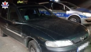 czarny opel sprawcy kolizji i radiowóz policyjny