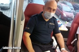 policjant podczas oddawania krwi