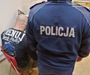 policjant z zatrzymanym mężczyzną