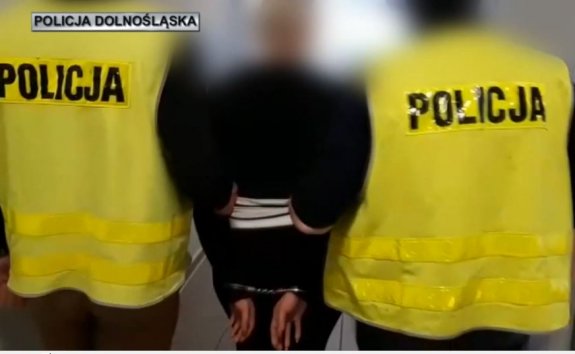 dwaj policjanci prowadzą zatrzymaną kobietę