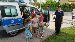 policjantka z dziećmi przy radiowozie