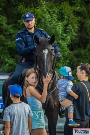 policjant na koniu służbowym wśród dzieci