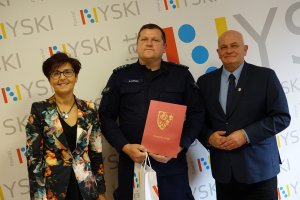Starosta nyski Andrzej Kruczkiewicz oraz dyrektor PCPR w Nysie Krystyna Wilisowska z nagrodzonym policjantem