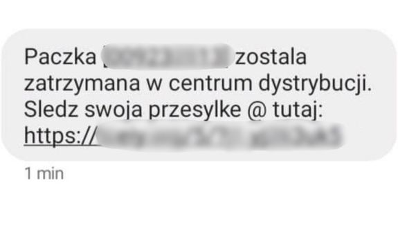 Opis treści: Paczka (zamazany numer) została zatrzymana w centrum dystrybucji. Sledz swoja przesylka @ tutaj: zamazany link