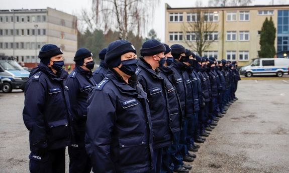 stojący w dwuszeregu umundurowani policjanci