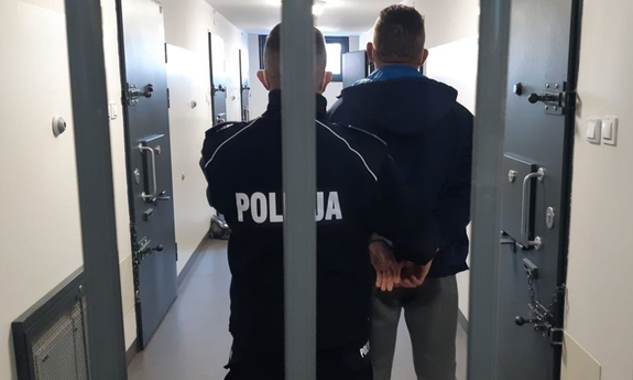 policjant z zatrzymanym mężczyzną