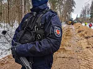 umundurowani policjanci zabezpieczają budowę zapory na granicy z Białorusią, patrolują i obserwują rejon oraz dbają o bezpieczeństwo osób wykonujących prace budowlane na granicy.