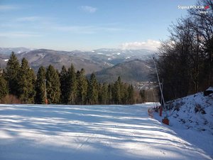 grafika-dzień, zima, śnieg, stok narciarski, widok w kierunku zjazdu, w tle szczyty górskie