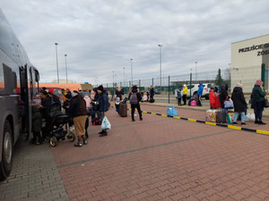 uchodźcy wsiadają do autokaru