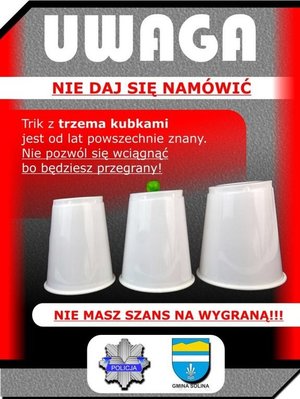 plakat ostrzegający przed oszustami proponującymi grę w trzy kubki