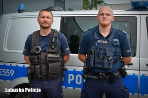 Policjanci na tle radiowozu