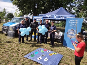 Policjanci pozują do zdjęcia przy namiocie profilaktycznym.