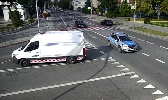 Na zdjęciu widać radiowóz oznakowany który pilotuje auto z rannym dzieckiem do szpitala